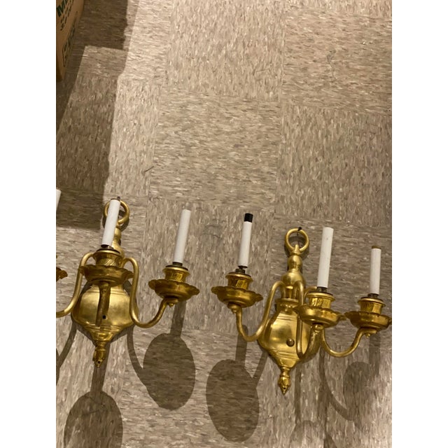 A pair of circa 1920's Caldwell Williamsburg style sconces with 3 lights
