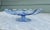 A beautiful mid‑century hand‑blown art glass pedestal bowl in a soft light‑blue tone, featuring a scalloped rim, natural...