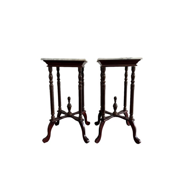 A pair of marble and wood plant stands in a Victorian revival style. c. Late 20th Century Dimensions: 16.75" square at...