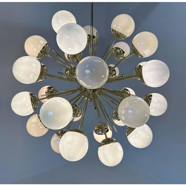 This chandelier was produced in Murano in a mid-century style and it is composed of 30 glass iridescent spheres while the...