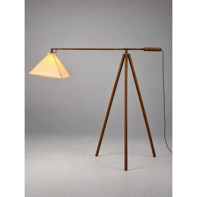 Striking vintage tripod floor lamp with a distinctive architectural design. The lamp features a tall three-legged metal...