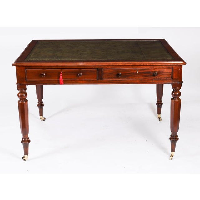 A superb antique victorian partners flame mahogany writing table, circa 1860. The rectangular top features a moulded edge...