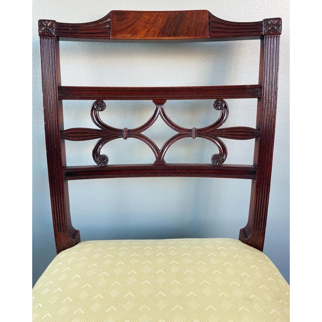 A choice pair of Regency mahogany side chairs with beautiful floral, and reeded backs. These chairs have beautiful details...