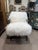 A luxurious and inviting accent chair by Four Hands, upholstered in plush Mongolian sheepskin in a soft ivory hue. The...