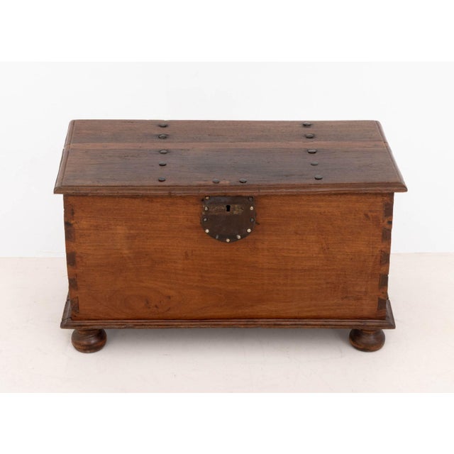 Dutch East Indies Hardwood Chest, 18th century, with metal hardware above bun feet. 16" H x 27.5" W x 15.5" D. Provenance:...