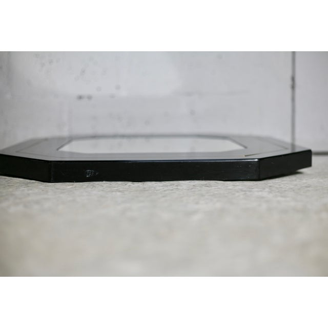 70s mirror, black lacquered wood, brass edging. Octagonal. Small marks and scratches. Good condition. Beautiful mirror 1970