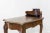 This small Baroque style desk was manufactured in the 19th century in France. It is made of walnut with leather and bronze...