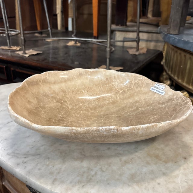 A lovely onyx bowl with natural edges. This bowl would make a beautiful addition to a coffee table with books, or a side...