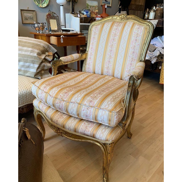 Lovely old bergere with yellow and white brocade stripe. Down seat cushion.