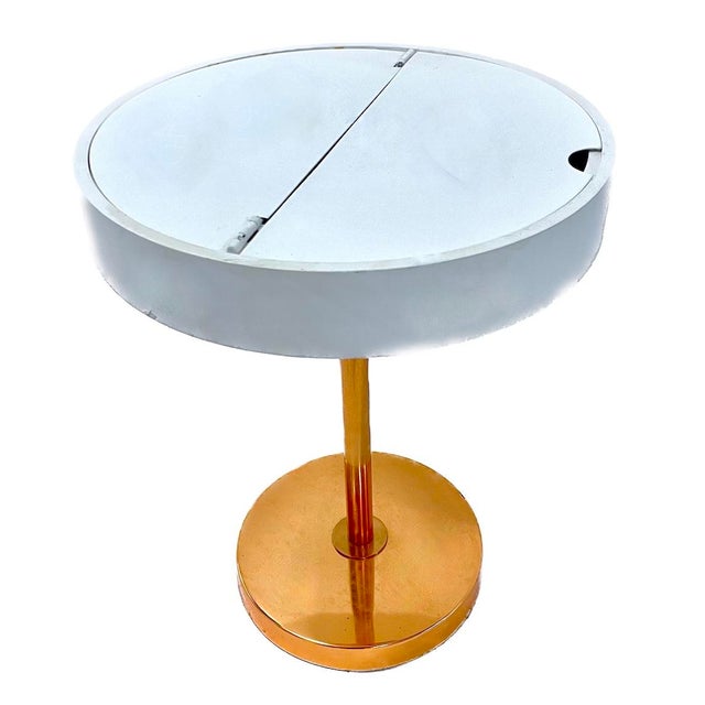 Mid-Century Modern style round compartment side table with painted steel hinged top to flip open to access storage...