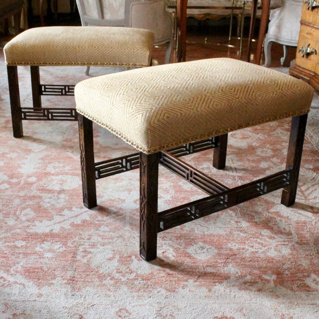 A very good pair of English mahogany benches with blind fret carved legs connected by unusually complex open fretwork...