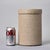 Hand-thrown stoneware vessel with fitted lid in natural earth tones. The heavily textured surface showcases the organic...