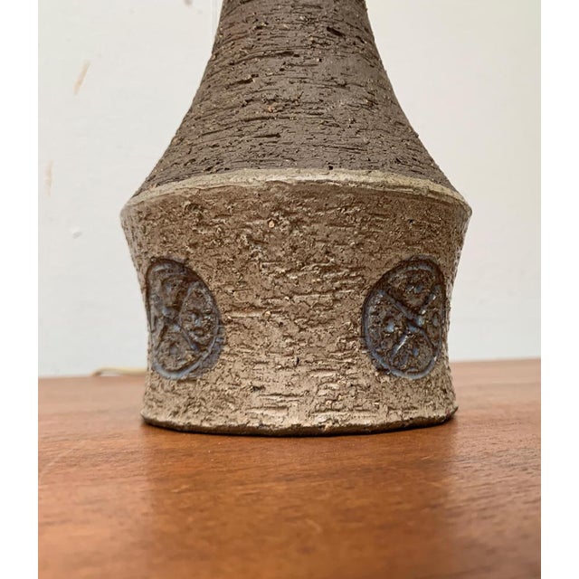 Mid Century ceramic table lamp from Denmark. The ceramic base features a simple ornament all around. European Plug (up to...