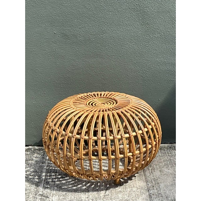 This iconic vintage Italian ottoman is a masterclass in Mid-Century Organic Modernism, meticulously designed in the...