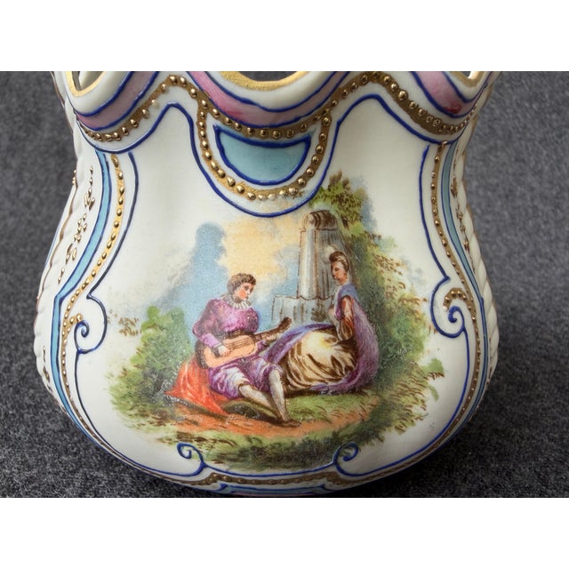 Vintage Royal Rudolstadt hand painted bisque basket with double handle. A Renaissance couple on one side, a flower bouquet...