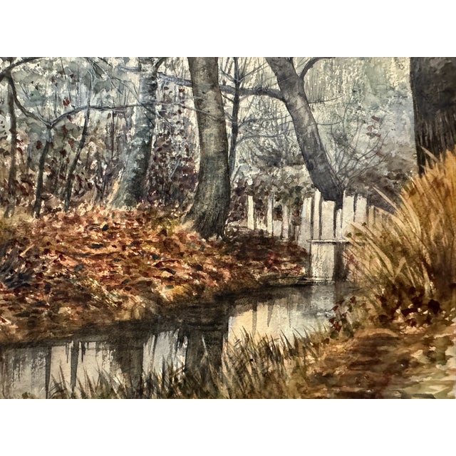 Original watercolor on textured paper depicting a wooded landscape with a narrow reflective stream, small white...
