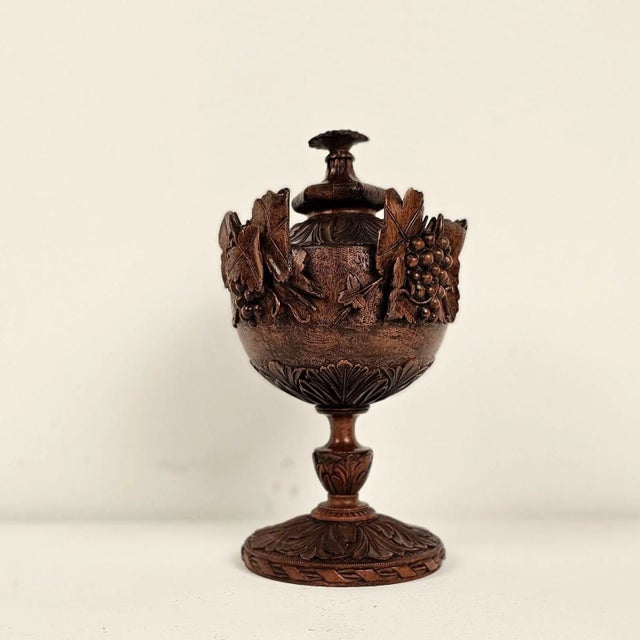 A German or Swiss carving of an urn with grapes, 19th century. From a tradition of making carvings in winter for sale in...