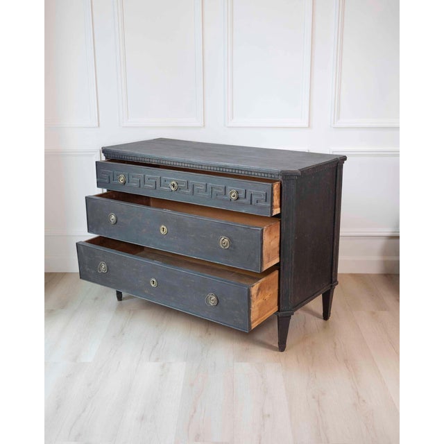 A striking Swedish Gustavian chest of drawers from circa 1790, defined by its crisp neoclassical lines and elegant Greek...