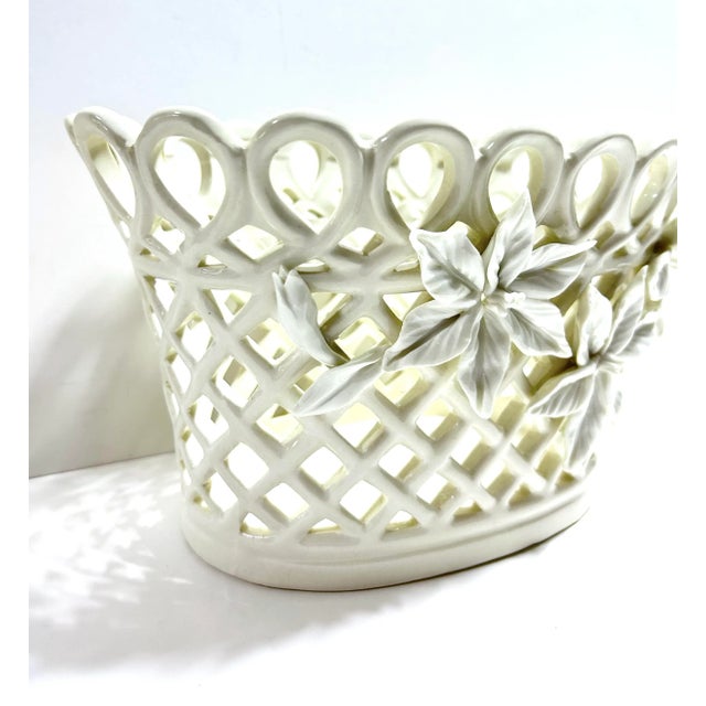 A beautifully detailed vintage porcelain cachepot featuring pierced latticework and sculpted floral decoration. The ivory...