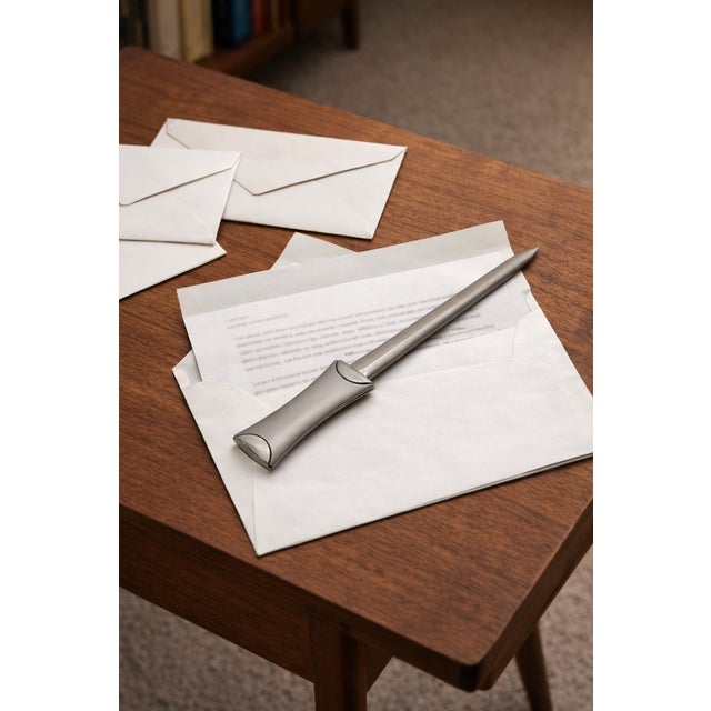 Sleek vintage stainless steel letter opener with a refined, modernist profile and smooth tapered blade. Designed for both...