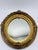 This elegant antique oval giltwood wall mirror exudes classic European charm with its richly ornamented frame and warm,...
