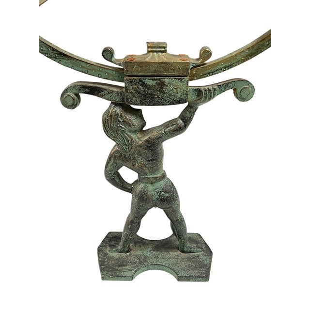 Figurative bronze armillary with verdigris patina measuring 31 inches tall and 16 1/4 inches in diameter.