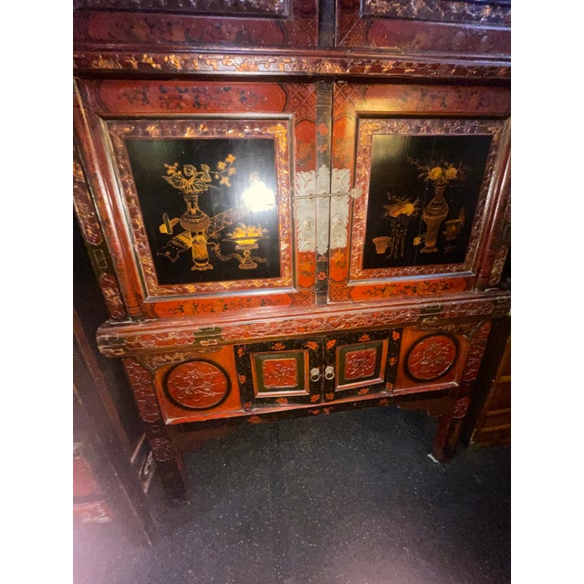 Antique Chinese hand made wood cabinet from the 19th century. It has a lot of carving and wonderful butterfly lock plates....