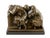 This bronze sculpture depicts two figures captured in a moment of shared rest. The characters are rendered with the...