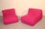 This pair of lounge chairs was produced in Italy in the 1960s. They are upholstered in fuschia colored fabric and are in...