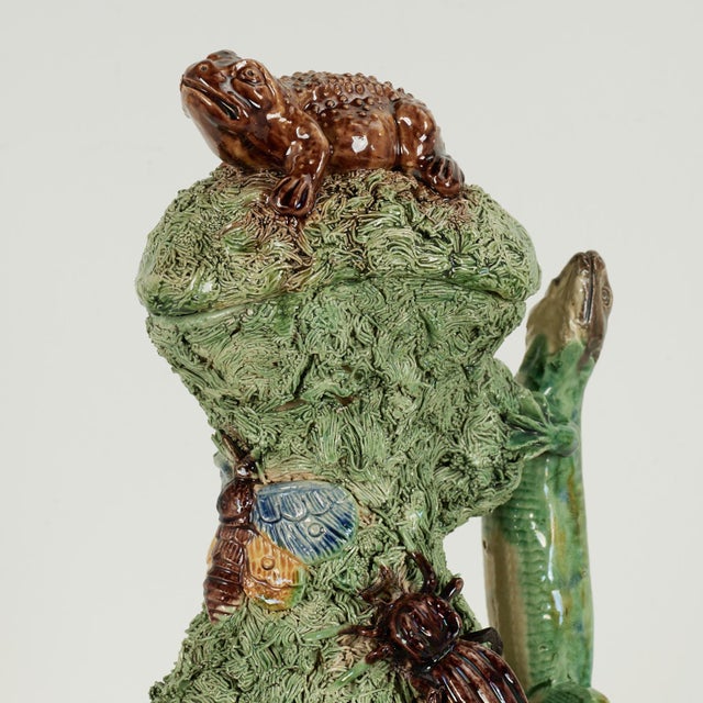 Whimsical 19th century earthenware lidded pitcher with an eccentric composition of frogs, bugs and lizards on a grassy...