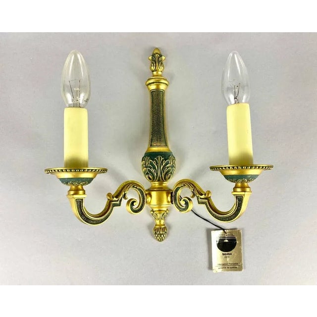 Vintage lumalux paris brass wall lamp in the empire style. manufactured in france. it features bright gold and green...
