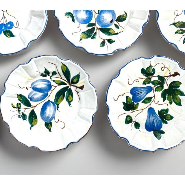 Beautiful set of twelve (12) Italian Umbrian faience plates. Each hand‑painted plate adorned with a blue fruit motif —...