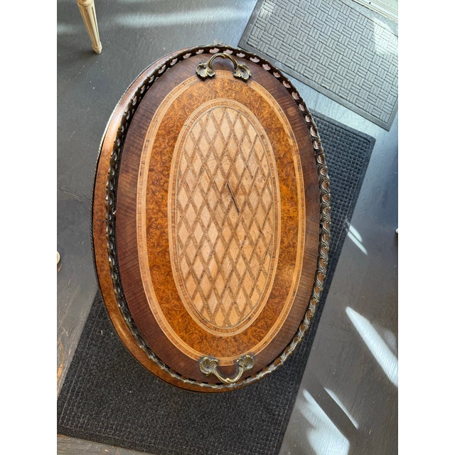 This is an antique oval planter. It is Burled walnut and fruitwood. It has ormolu. It has a lattice pattern. It is...