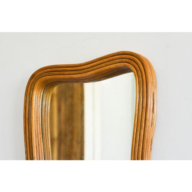 This beautifully crafted Reka wall mounted mirror is made of pencil reed rattan, providing a unique and elegant texture....