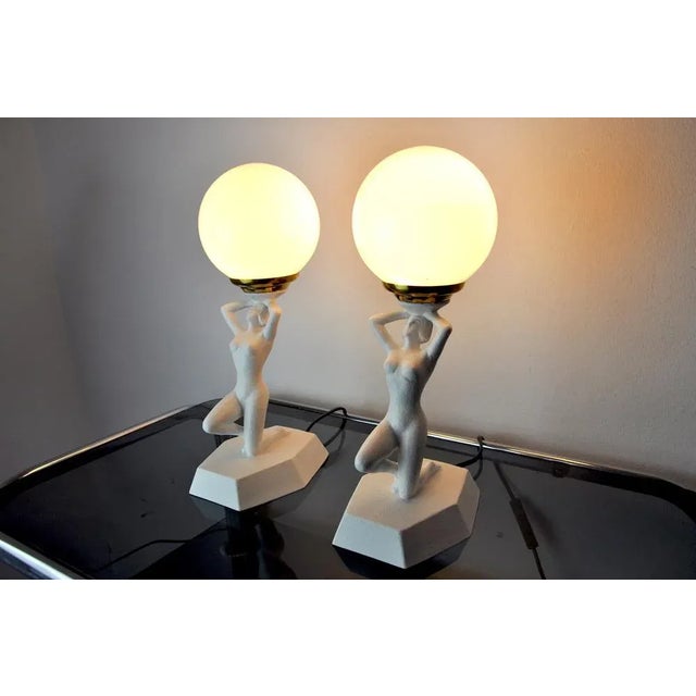 Very nice pair of art deco table lamps signed onice eth representing a woman playing ball, designated and produced in the...