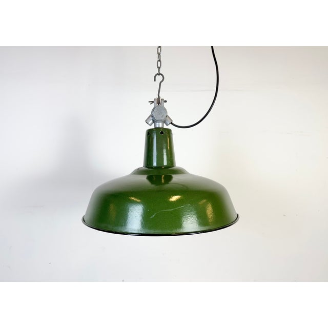 Industrial green enamel pendant light made in France during the 1960s. White enamel inside the shade. Cast aluminium top....