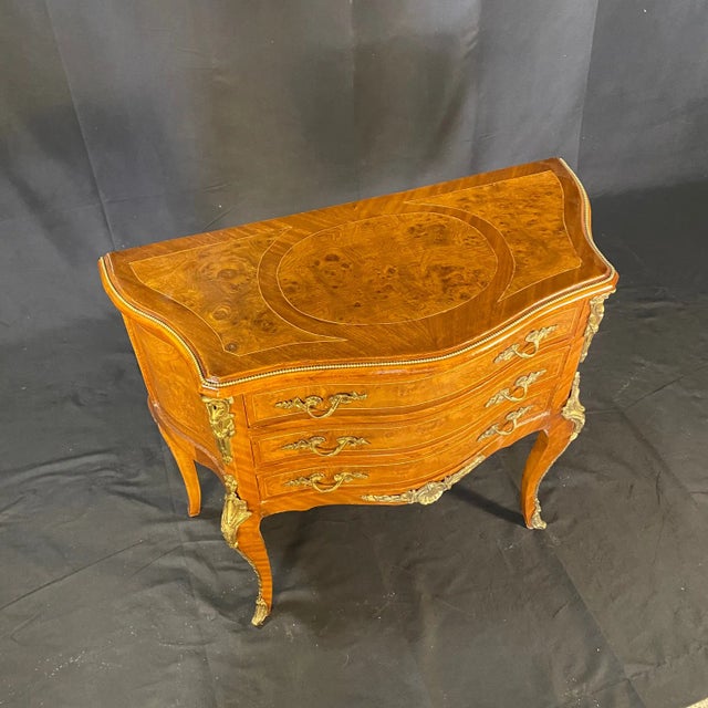 Pair of petite French Louis XV commodes, which can also serve as side tables or nightstands. Each with three drawers, all...
