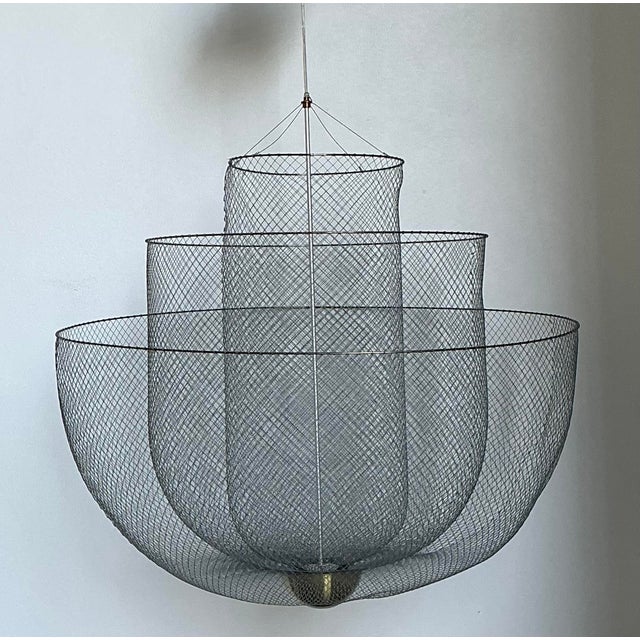 Designed by Rick Tegelaar for Moooi, the "Meshmatics" chandelier is a triumph of industrial artistry and ethereal...