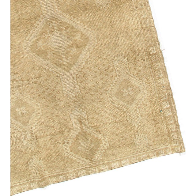 This vintage Turkish Oushak rug, hand-knotted in the 1950s, beautifully embodies character, tradition, pattern, and...