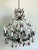 This stunning vintage chandelier epitomizes the dramatic elegance of the Hollywood Regency era, blending classic form with...