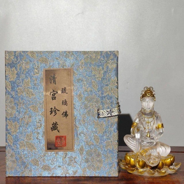 This exquisite vintage statue depicts a seated Guanyin (Bodhisattva) resting upon a golden lotus base. Crafted from...