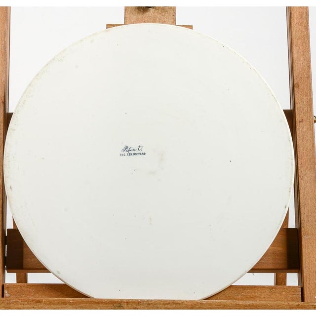 Glazed ceramic underplate signed soc. Cer. Richard with border decorated with green floral motifs measures 30 x 0.5...