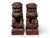 A pair of carved wood Chinese foo lions. Red coloring with traces of gilding. Appears to be a male and female. The taller...