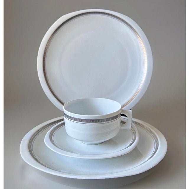 A refined French porcelain service by Bernardaud of Limoges in the Parly pattern. Executed in a classic modern style with...