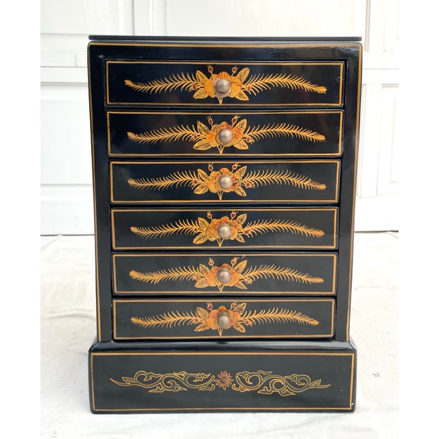 Here is a beautiful Asian, Japanese, Chinoiserie black lacquered jewelry box that is adorned with hand-painted floral and...