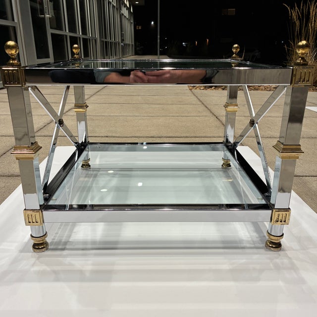 Chrome and brass end table with tiered glass inset having x-stretcher side members each corner ending in ball finial's...