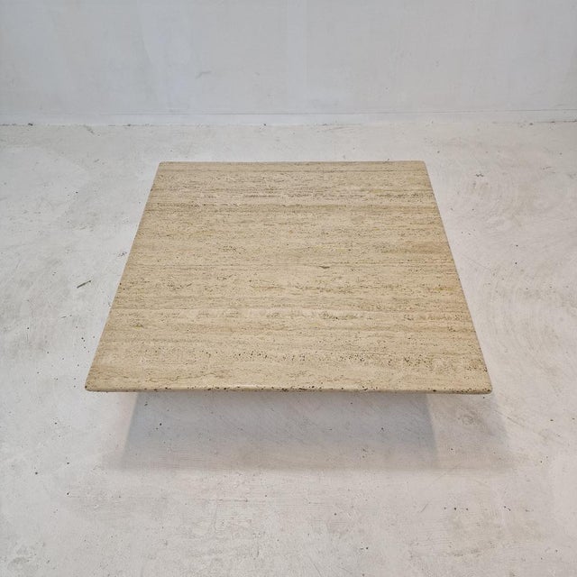 Very nice square shaped Italian coffee or side table handcrafted out of travertine, 1980s. It is made of beautiful...