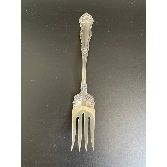 A medium solid cold meat serving fork in the Arbutus pattern by Wm Rogers & Sons / International Silver. Designed by...