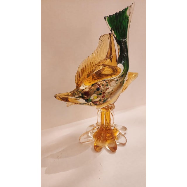 This listing features a beautiful orange Murano glass fish sculpture. This fish has a green tail with a transparent orange...