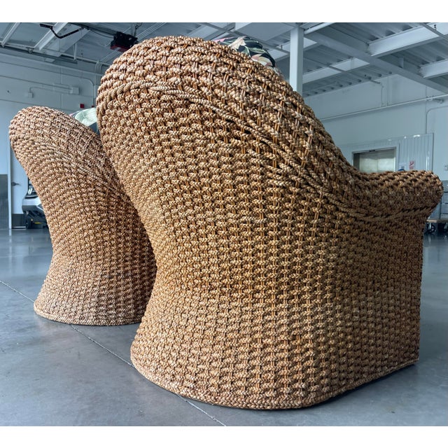 Exceptional pair of sculptural woven lounge armchairs featuring dramatic curved silhouettes and densely braided natural...